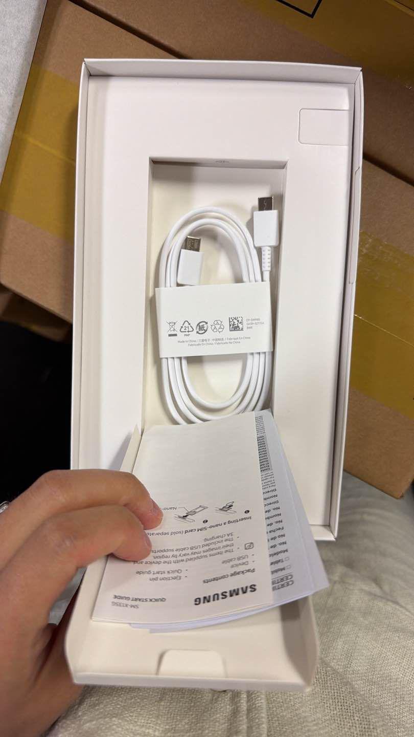 Actual open tablet box with cable and printed guides